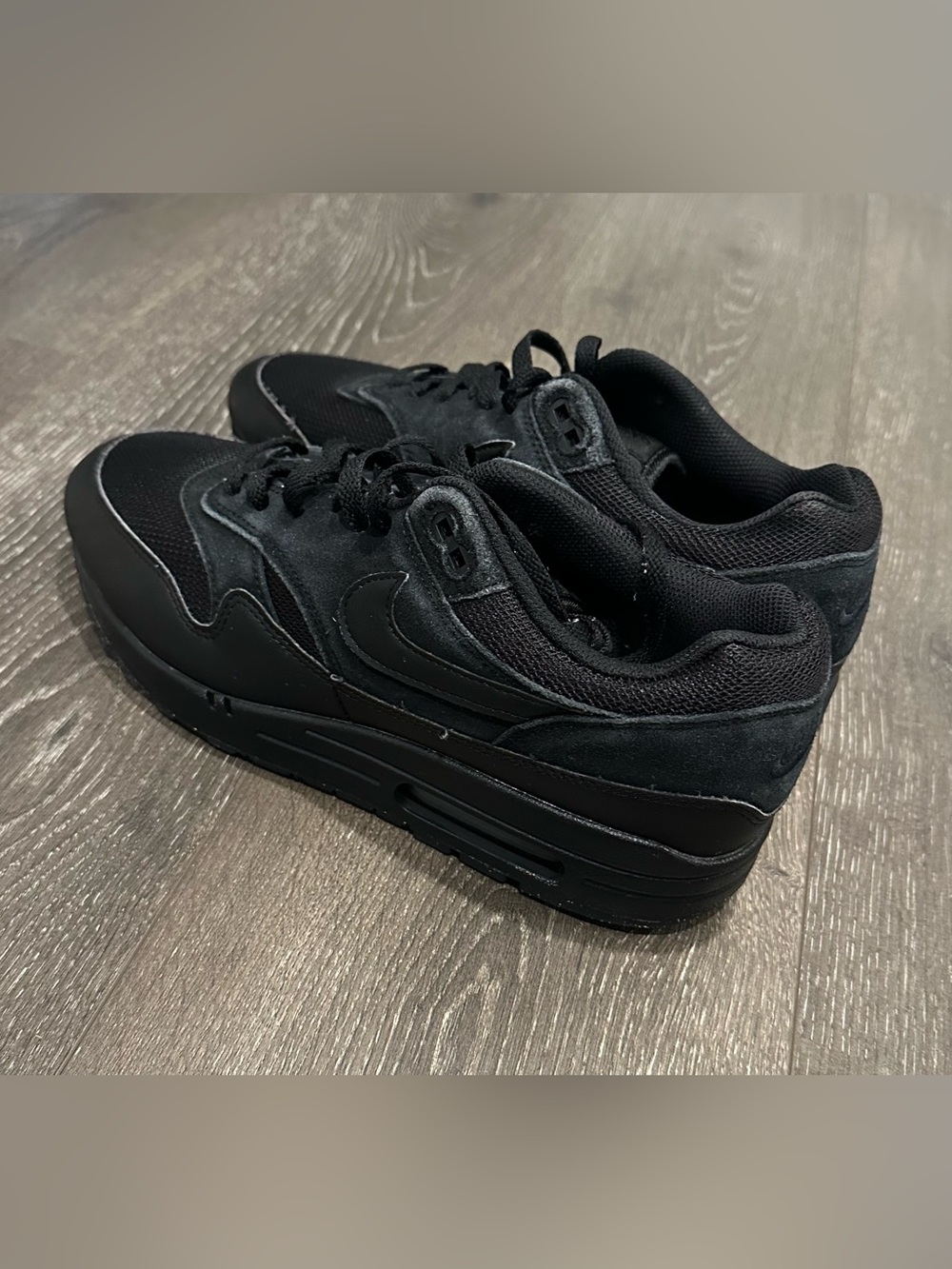Nike Air Max 1  Men's Black Low-Top Suede & Mesh Sneakers.